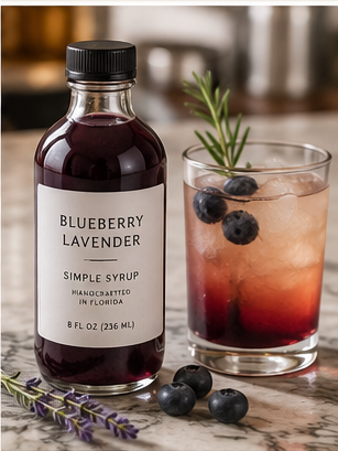House-made syrup bottle beside an iced coffee or cocktail-style drink from Resident Coffee